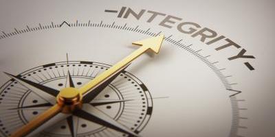 Clock face with large hand pointing to the word ‘Integrity’